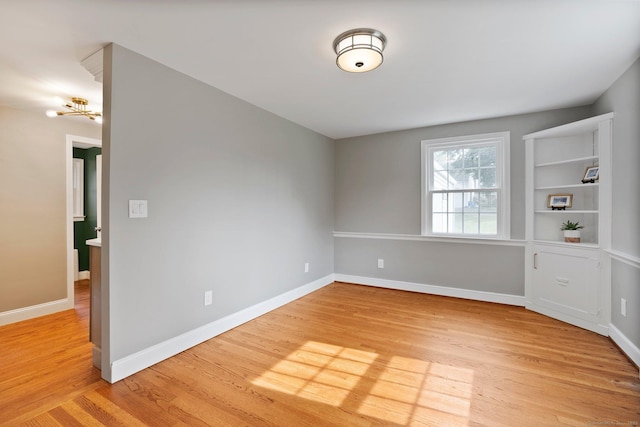 114 Boulter Rd, Wethersfield, CT 06109 - unfurnished room featuring light wood finished floors and a chandelier