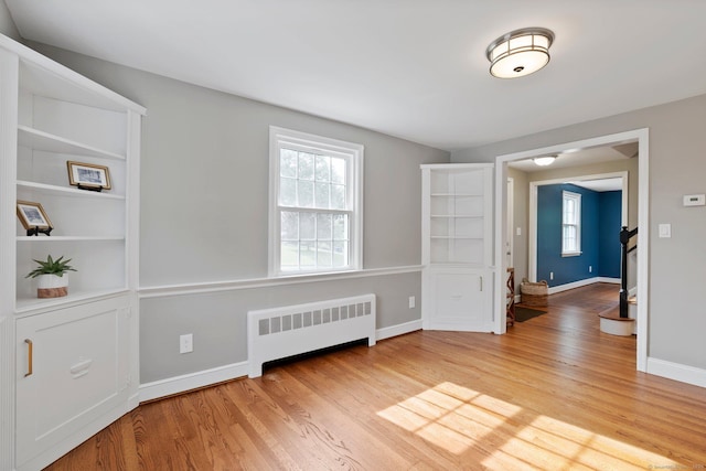 114 Boulter Rd, Wethersfield, CT 06109 - unfurnished room featuring radiator heating unit, plenty of natural light, and light wood-type flooring