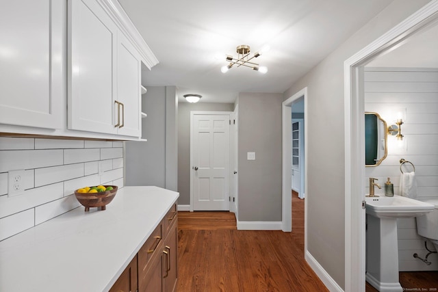 114 Boulter Rd, Wethersfield, CT 06109 - kitchen featuring decorative backsplash, white cabinetry, and dark wood-style floors
