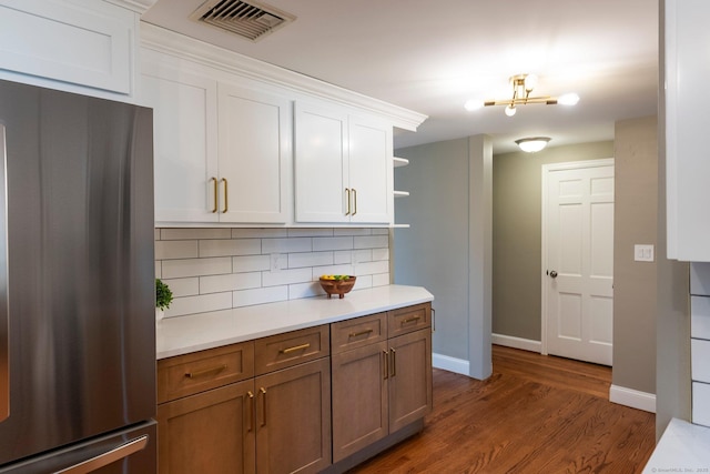114 Boulter Rd, Wethersfield, CT 06109 - kitchen featuring stainless steel refrigerator, open shelves, tasteful backsplash, light countertops, and dark wood-style floors