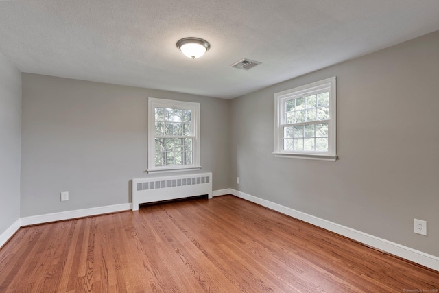 114 Boulter Rd, Wethersfield, CT 06109 - unfurnished room with radiator, plenty of natural light, and wood finished floors