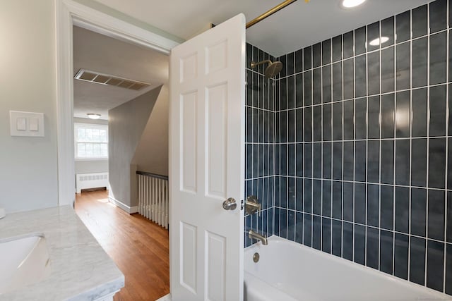 114 Boulter Rd, Wethersfield, CT 06109 - bathroom featuring radiator heating unit, shower / washtub combination, wood finished floors, and vanity