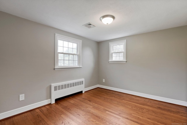 114 Boulter Rd, Wethersfield, CT 06109 - empty room with radiator heating unit and wood finished floors