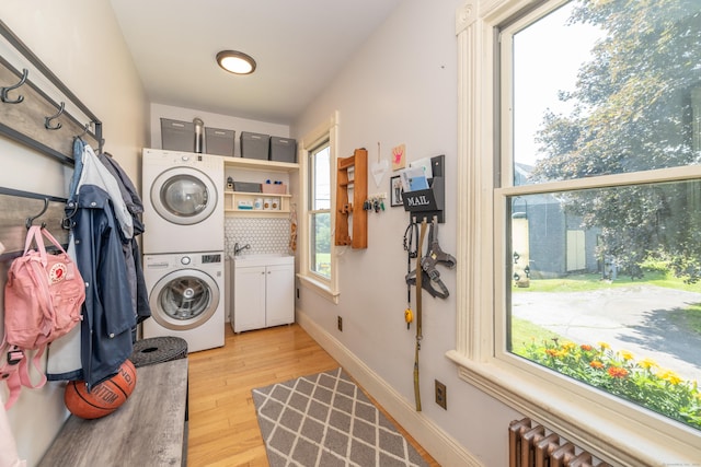 45 Harris Fuller Rd, Preston, CT 06365 - laundry room with stacked washer / drying machine, light wood-type flooring, and radiator heating unit