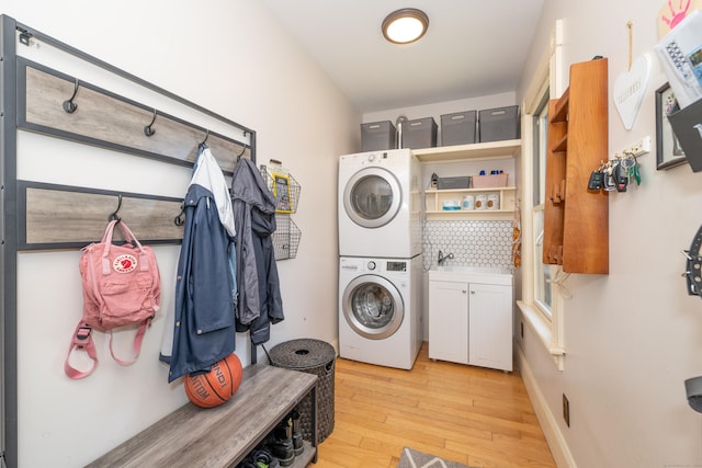 45 Harris Fuller Rd, Preston, CT 06365 - laundry room featuring estacked washer and dryer, cabinet space, and light wood-style flooring