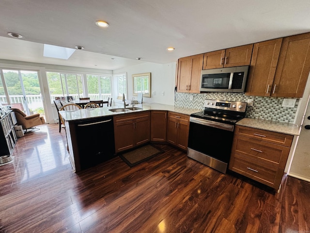 34 Park St, Griswold, CT 06351 - kitchen with stainless steel appliances, a peninsula, healthy amount of natural light, dark wood-type flooring, and recessed lighting