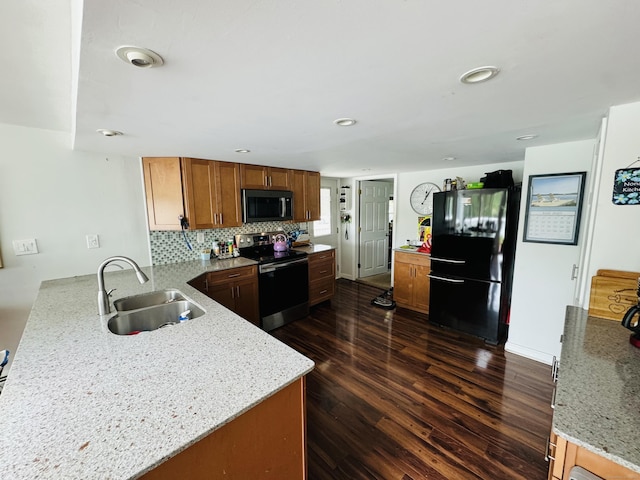 34 Park St, Griswold, CT 06351 - kitchen featuring appliances with stainless steel finishes, dark wood-style floors, brown cabinets, light stone countertops, and decorative backsplash