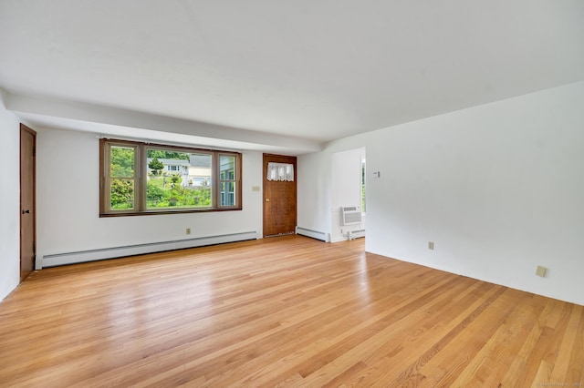 442 Merrow Rd, Tolland, CT 06084 - unfurnished living room with a baseboard radiator, a baseboard heating unit, light wood-type flooring, and an AC wall unit