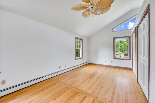 442 Merrow Rd, Tolland, CT 06084 - unfurnished bedroom with a baseboard heating unit, wood finished floors, lofted ceiling, a closet, and a ceiling fan