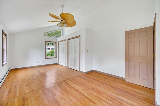 442 Merrow Rd, Tolland, CT 06084 - unfurnished bedroom with two closets, light wood finished floors, a baseboard heating unit, high vaulted ceiling, and a ceiling fan