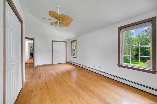 442 Merrow Rd, Tolland, CT 06084 - unfurnished bedroom with baseboard heating, multiple windows, light wood-type flooring, and lofted ceiling