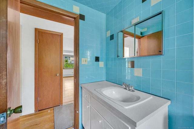442 Merrow Rd, Tolland, CT 06084 - bathroom with vanity, tile walls, wood finished floors, and backsplash