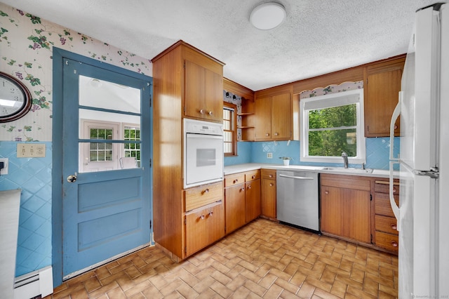 442 Merrow Rd, Tolland, CT 06084 - kitchen with white appliances, wallpapered walls, light countertops, open shelves, and brown cabinetry