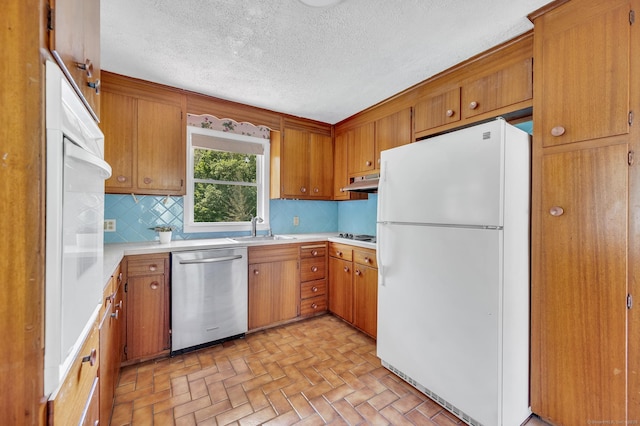 442 Merrow Rd, Tolland, CT 06084 - kitchen with white appliances, under cabinet range hood, tasteful backsplash, light countertops, and brown cabinets