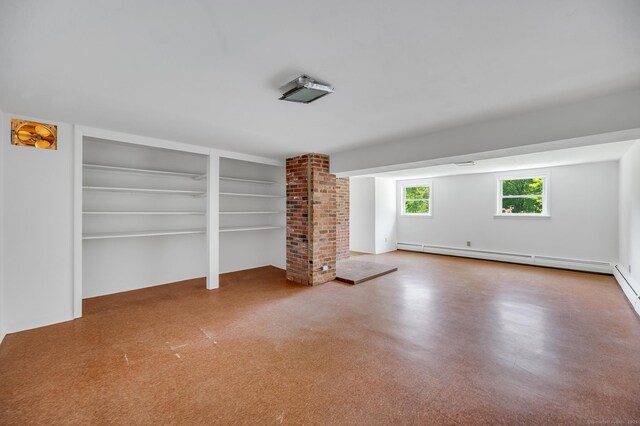 442 Merrow Rd, Tolland, CT 06084 - unfurnished living room with a baseboard heating unit and built in shelves