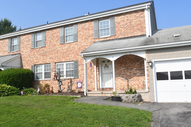 4 Whisconier Vlg Unit 4, Brookfield, CT 06804 - view of property featuring a front lawn, brick siding, a garage, covered porch, and asphalt driveway