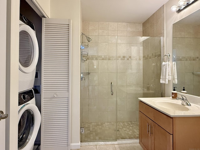 34 Schoolhouse Dr Unit 405, West Hartford, CT 06110 - full bathroom featuring stacked washer / dryer, a shower stall, vanity, and tile patterned floors