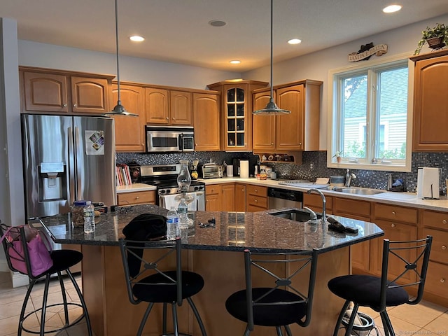 42 Bluff St, Westbrook, CT 06498 - kitchen featuring appliances with stainless steel finishes, light tile patterned flooring, a center island with sink, a kitchen bar, and recessed lighting