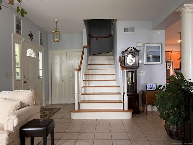 42 Bluff St, Westbrook, CT 06498 - entryway featuring stairs, light tile patterned floors, and decorative columns