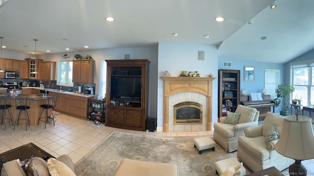 42 Bluff St, Westbrook, CT 06498 - living room with recessed lighting, light tile patterned floors, plenty of natural light, a tiled fireplace, and vaulted ceiling