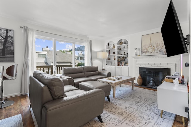 32 Glenview Dr Unit 32, Cromwell, CT 06416 - living room featuring built in shelves, crown molding, wood finished floors, and a fireplace