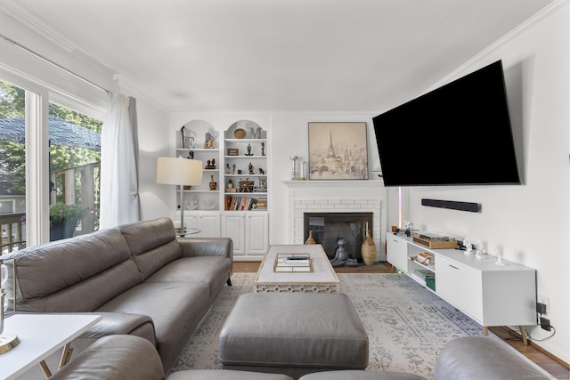 32 Glenview Dr Unit 32, Cromwell, CT 06416 - living area with crown molding, built in features, a brick fireplace, and light wood-style floors