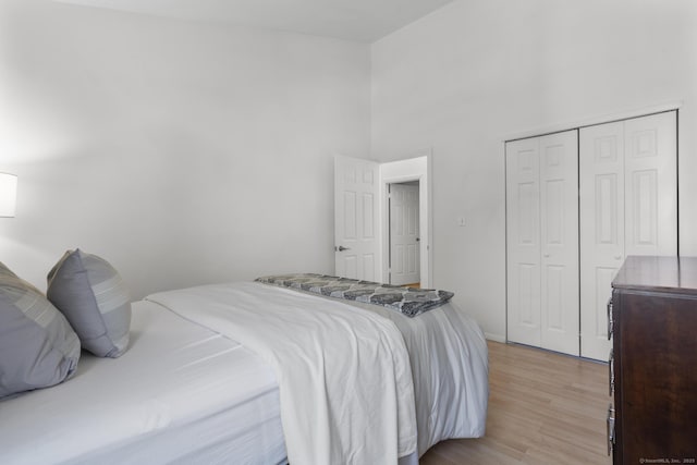 32 Glenview Dr Unit 32, Cromwell, CT 06416 - bedroom featuring light wood-style flooring, a closet, and a towering ceiling