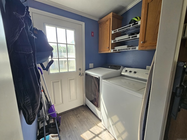 91 Chaffeeville Rd Trlr 16, Mansfield, CT 06250 - washroom with washing machine and clothes dryer, cabinet space, crown molding, and light wood-type flooring