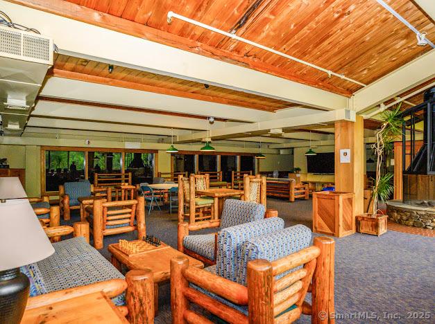172 Old Farms Rd Unit 172, Torrington, CT 06790 - miscellaneous room with carpet floors and a wooden ceiling with exposed beams