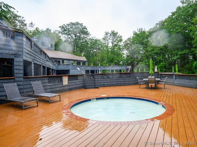 172 Old Farms Rd Unit 172, Torrington, CT 06790 - view of swimming pool with a wooden deck and view of wooded area