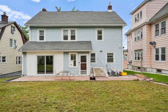 73 Atwater St, Bridgeport, CT 06604 - back of property featuring a patio, a chimney, a lawn, and a shingled roof