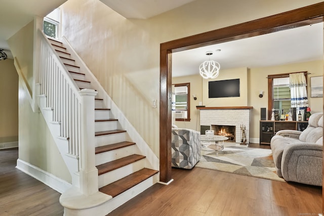 73 Atwater St, Bridgeport, CT 06604 - stairs featuring wood finished floors, a fireplace, and cooling unit