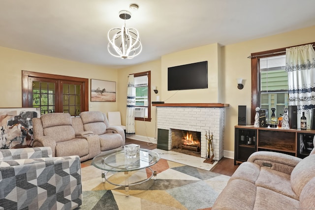 73 Atwater St, Bridgeport, CT 06604 - living room featuring plenty of natural light, a fireplace, a chandelier, and wood finished floors