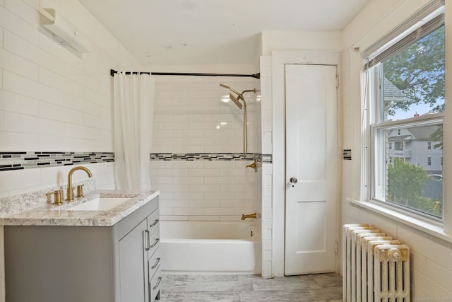 73 Atwater St, Bridgeport, CT 06604 - bathroom with radiator, plenty of natural light, shower / tub combo, vanity, and tile walls