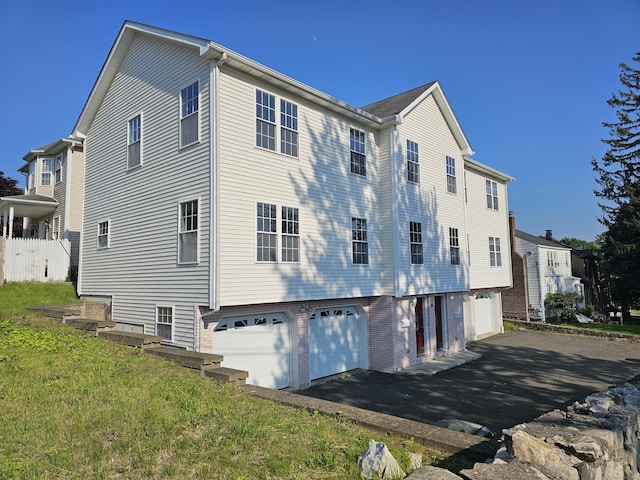 26 Roger Ave, Danbury, CT 06810 - view of property exterior featuring a garage and asphalt driveway