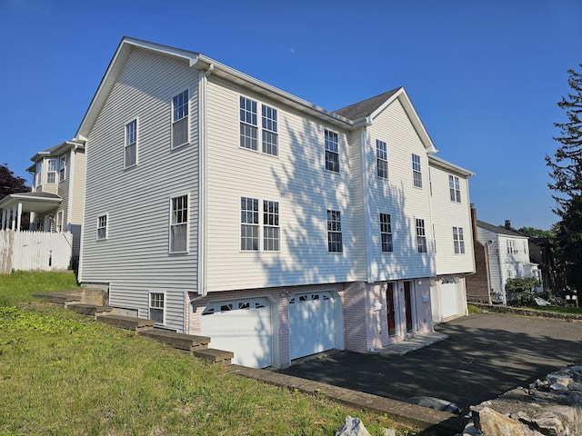 26 Roger Ave, Danbury, CT 06810 - view of property exterior with a garage and driveway