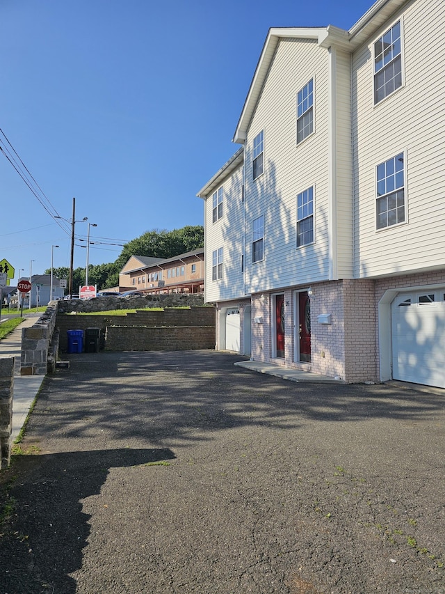 26 Roger Ave, Danbury, CT 06810 - exterior space with an attached garage and asphalt driveway