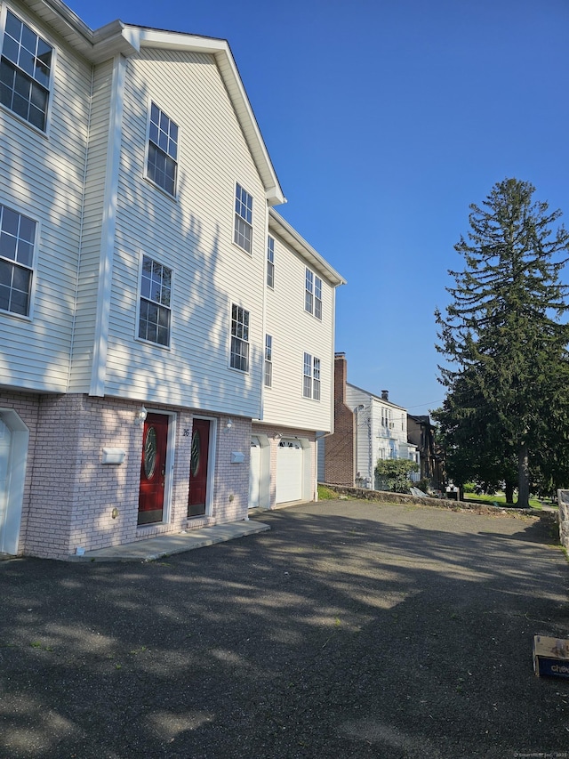 26 Roger Ave, Danbury, CT 06810 - view of building exterior with driveway and an attached garage