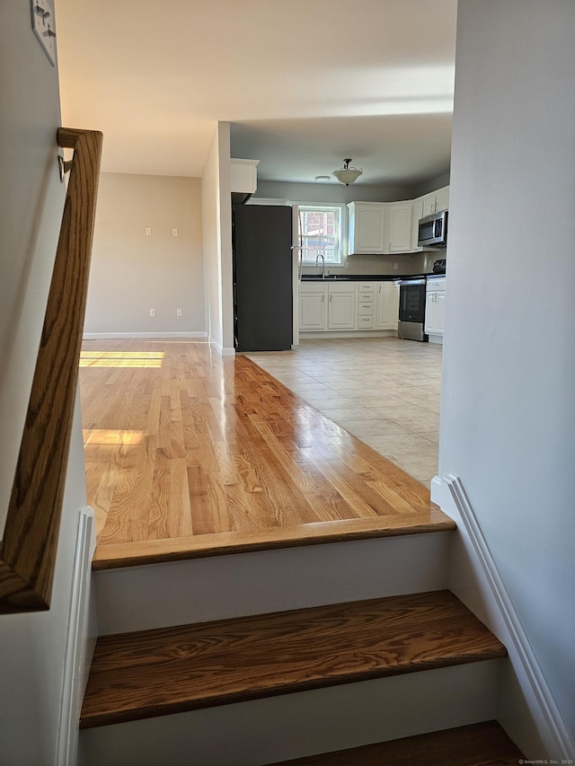 26 Roger Ave, Danbury, CT 06810 - interior space featuring a sink and light wood-type flooring