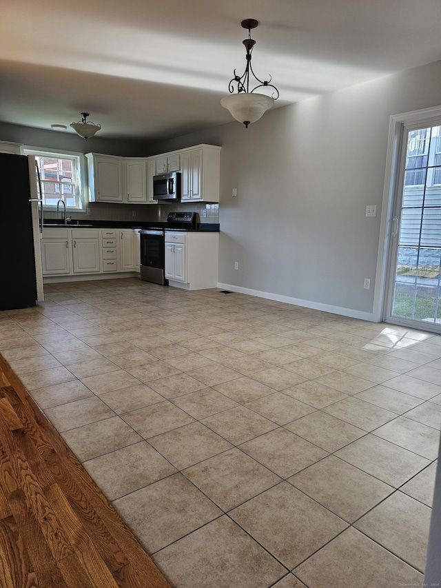 26 Roger Ave, Danbury, CT 06810 - kitchen featuring appliances with stainless steel finishes, dark countertops, healthy amount of natural light, and hanging light fixtures