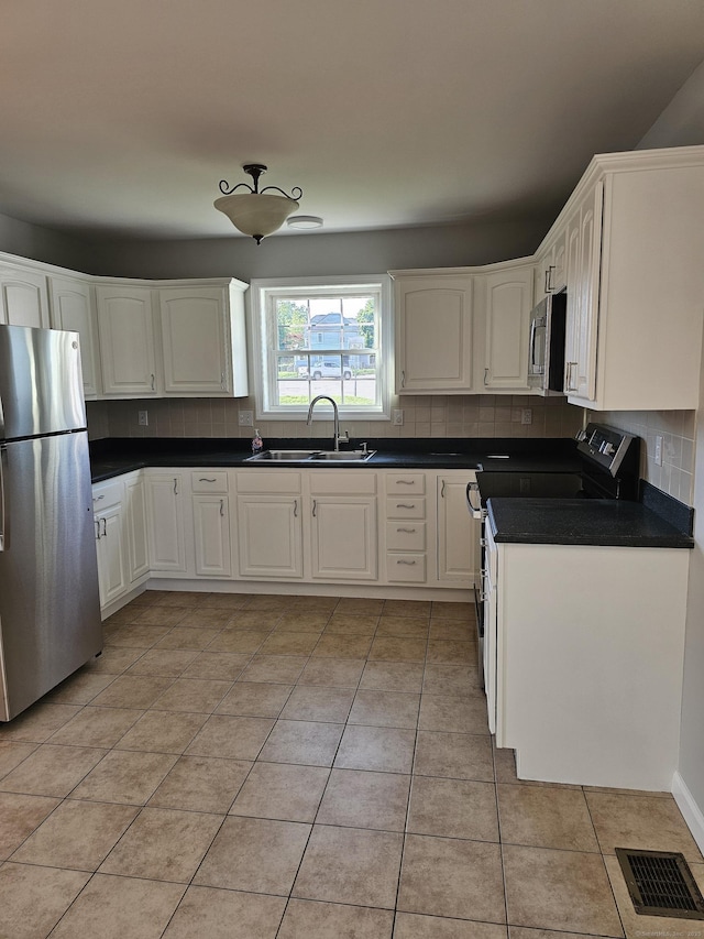 26 Roger Ave, Danbury, CT 06810 - kitchen featuring appliances with stainless steel finishes, tasteful backsplash, and light tile patterned flooring