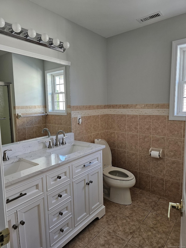 26 Roger Ave, Danbury, CT 06810 - full bathroom with tile walls, tile patterned flooring, healthy amount of natural light, a wainscoted wall, and a shower stall