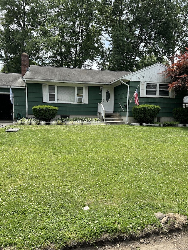 71 Saddle Rd, Norwalk, CT 06851 - view of front of house with a front yard, entry steps, a chimney, and roof with shingles