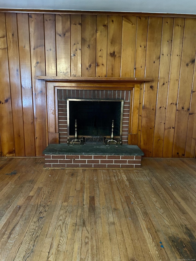 71 Saddle Rd, Norwalk, CT 06851 - detailed view of a brick fireplace, wood finished floors, and wood walls