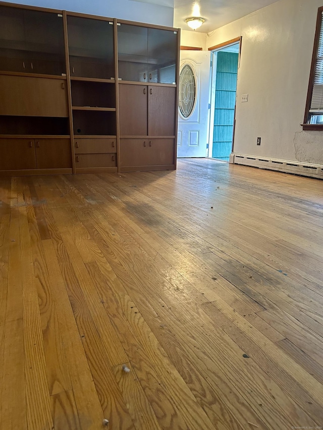 71 Saddle Rd, Norwalk, CT 06851 - unfurnished living room featuring baseboard heating and wood-type flooring