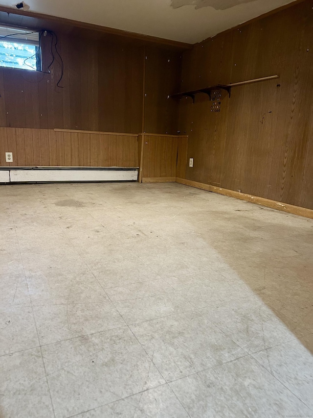 71 Saddle Rd, Norwalk, CT 06851 - below grade area with wooden walls, a baseboard radiator, and tile patterned floors