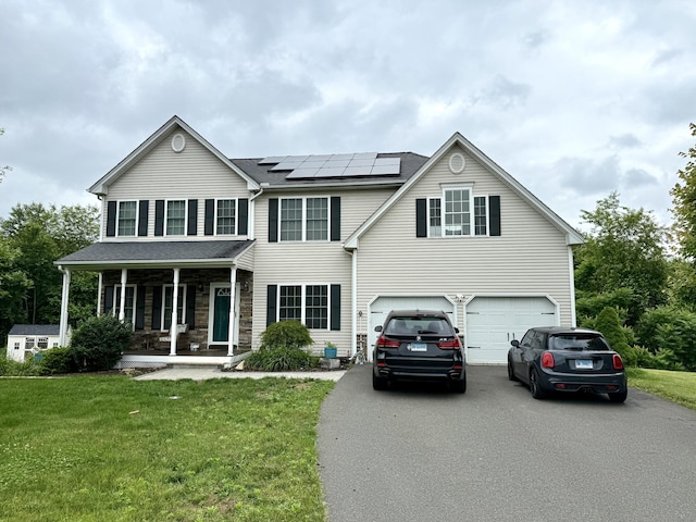 11 Larensen Rdg, Bloomfield, CT 06002 - view of front of home with covered porch, driveway, a front lawn, solar panels, and a garage