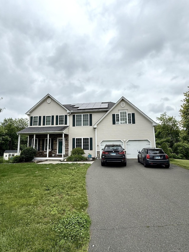 11 Larensen Rdg, Bloomfield, CT 06002 - view of front of house featuring a porch, driveway, a front yard, and solar panels