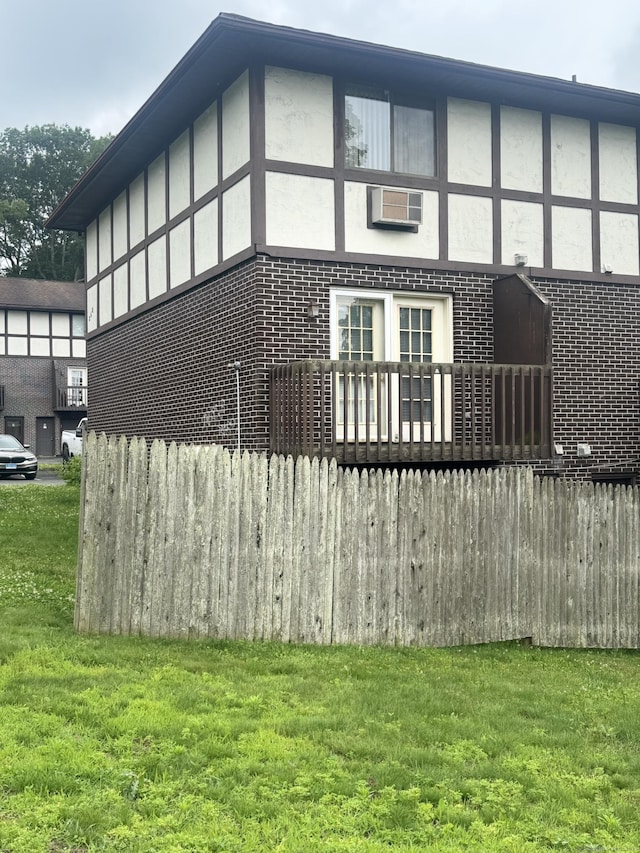 260 Scott Rd Apt 1, Waterbury, CT 06705 - view of property exterior with brick siding, a lawn, stucco siding, and a wall unit AC
