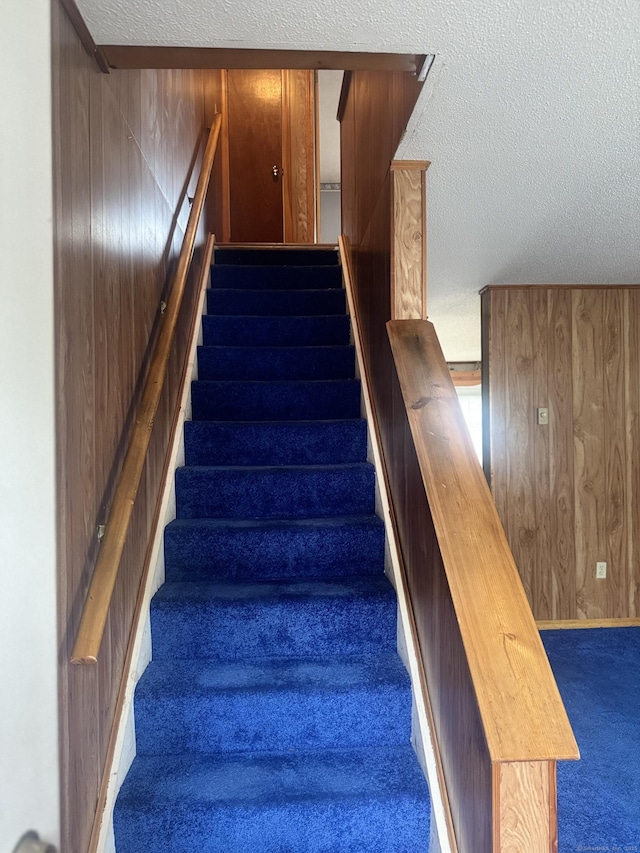 260 Scott Rd Apt 1, Waterbury, CT 06705 - stairs featuring carpet, a textured ceiling, and wood walls
